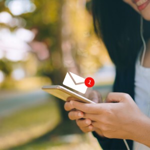 Woman hand using smartphone to send and receive email.